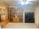 Bright living room featuring a large bookshelf, entertainment center, and neutral carpet creating a cozy atmosphere at 223 Pinewood Dr, Eustis, FL 32726