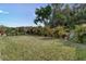 Manicured backyard featuring well-kept lawn, tasteful landscaping, and decorative fencing at 2271 Delhi Pl, Sanford, FL 32771