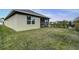 Manicured backyard with a black metal fence and a screened in patio area at 2271 Delhi Pl, Sanford, FL 32771