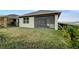 Spacious backyard featuring a screened lanai, and lush landscaping by the fence at 2271 Delhi Pl, Sanford, FL 32771