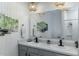 Stylish bathroom features double sinks, modern light fixtures, and gray cabinetry at 2271 Delhi Pl, Sanford, FL 32771