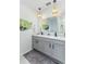 Elegant bathroom featuring double sinks, granite countertop, and modern light fixtures at 2271 Delhi Pl, Sanford, FL 32771