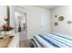 Comfortable bedroom with stylish decor, including wicker wall art and a view into the hallway at 2271 Delhi Pl, Sanford, FL 32771
