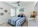 Bedroom with blue and white bedding, natural light, and decorative wall baskets at 2271 Delhi Pl, Sanford, FL 32771
