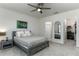 Bedroom with a ceiling fan featuring a connecting bathroom and a walk in closet at 2271 Delhi Pl, Sanford, FL 32771