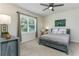 Cozy bedroom with neutral tones, featuring a ceiling fan and a view to the outside at 2271 Delhi Pl, Sanford, FL 32771