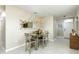 Well-lit dining area with neutral decor, pendant lighting, and access to the home's front door at 2271 Delhi Pl, Sanford, FL 32771