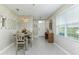 Bright dining room with tile floors, modern light fixture and an accent mirror on the wall at 2271 Delhi Pl, Sanford, FL 32771