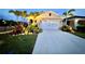 Charming single-Gathering home featuring a two-car garage, well-lit landscaping, and a concrete driveway at 2271 Delhi Pl, Sanford, FL 32771