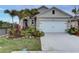 Charming single-Gathering home featuring a well-manicured lawn and landscaping, a two-car garage, and a spacious driveway at 2271 Delhi Pl, Sanford, FL 32771