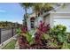 Charming front entrance with tropical plants and a black iron fence, enhancing the home's curb appeal at 2271 Delhi Pl, Sanford, FL 32771
