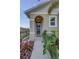 Inviting front entrance with colorful foliage and a welcoming pathway, enhanced by a neutral-toned exterior at 2271 Delhi Pl, Sanford, FL 32771