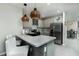 Open concept kitchen featuring stainless steel appliances, gray cabinets, and a center island with barstool seating at 2271 Delhi Pl, Sanford, FL 32771