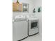 Bright laundry room featuring white washer and dryer units next to a window at 2271 Delhi Pl, Sanford, FL 32771