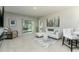 Bright living room with neutral color palette, plush carpet, and sliding glass doors to the screened in patio at 2271 Delhi Pl, Sanford, FL 32771