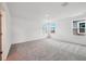 Spacious bedroom featuring plush carpet and multiple windows offering an abundance of natural light and scenic views at 2354 Broadbrook Dr, St Cloud, FL 34771