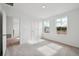 Sunlit bedroom with plush carpet, a closet and two windows offering scenic views and ample natural light at 2354 Broadbrook Dr, St Cloud, FL 34771