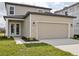 Home with a two-car garage, complemented by an inviting entrance and landscaped front yard at 2354 Broadbrook Dr, St Cloud, FL 34771