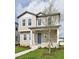 Charming two-story home featuring a welcoming front porch, blue door and neutral siding at 2354 Broadbrook Dr, St Cloud, FL 34771