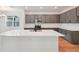 A well-appointed kitchen featuring stainless steel appliances, modern gray cabinets, and a large, bright quartz countertop at 2354 Broadbrook Dr, St Cloud, FL 34771