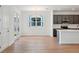 Open concept kitchen featuring hardwood floors, dark cabinetry, and stainless appliances at 2354 Broadbrook Dr, St Cloud, FL 34771