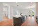 Bright kitchen features a large island with quartz countertop, stylish cabinets, and stainless steel appliances at 2354 Broadbrook Dr, St Cloud, FL 34771