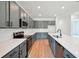 Stunning kitchen features gray cabinets, stainless steel appliances, and quartz countertops with bright natural light at 2354 Broadbrook Dr, St Cloud, FL 34771