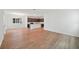 An expansive living room space features hardwood floors and a kitchen with stainless steel appliances and modern design at 2354 Broadbrook Dr, St Cloud, FL 34771