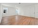 Bright living room featuring hardwood floors, two windows, and white trim at 2354 Broadbrook Dr, St Cloud, FL 34771