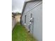 Side view of the house exterior, featuring well-maintained grass and a white fence at 236 Bay Head Dr, Kissimmee, FL 34743