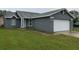 Charming single-story home featuring a well-maintained lawn and attached two-car garage at 236 Bay Head Dr, Kissimmee, FL 34743
