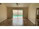 The house's living room includes sliding glass doors to allow access to a screened in pool area at 236 Bay Head Dr, Kissimmee, FL 34743