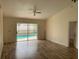 Bright and airy living room boasts hardwood floors and direct access to the pool area through sliding glass doors at 236 Bay Head Dr, Kissimmee, FL 34743