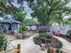 Expansive backyard with well-manicured landscaping, mature trees, and inviting trampoline for Gathering fun at 2410 E Church St, Orlando, FL 32803