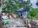 Quaint backyard features charming patio area, lush greenery, and cozy seating for outdoor relaxation at 2410 E Church St, Orlando, FL 32803