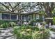 Inviting backyard features lush landscaping and a green home exterior at 2410 E Church St, Orlando, FL 32803