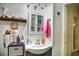 Charming bathroom showcasing a vanity, mirror, decorative shelf, and beadboard walls at 2410 E Church St, Orlando, FL 32803