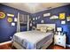 Serene bedroom features a bed with comfy pillows, and colorful wall decorations at 2410 E Church St, Orlando, FL 32803