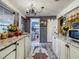 Well-lit kitchen featuring granite counters, a colorful rug, and access to the bathroom at 2410 E Church St, Orlando, FL 32803