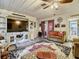 Cozy living room features wood ceiling, built-in entertainment center, and colorful area rug at 2410 E Church St, Orlando, FL 32803