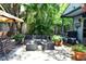 Relaxing outdoor patio area with wicker furniture, shade trees, and paved flooring at 2410 E Church St, Orlando, FL 32803
