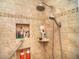 Accessible tiled shower boasts dual shower heads, a seating and grab bar at 2410 E Church St, Orlando, FL 32803