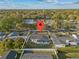 An aerial view of a home showcasing the property lines and surrounding neighborhood with mature trees at 2418 Whitehall Cir, Winter Park, FL 32792