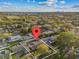 An aerial view showcasing the property's location within a neighborhood, surrounded by lush greenery at 2418 Whitehall Cir, Winter Park, FL 32792