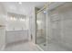 Modern bathroom featuring a glass walk-in shower, double vanity and updated fixtures at 2418 Whitehall Cir, Winter Park, FL 32792