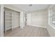 Bedroom showcasing open closet and wood-look flooring at 2418 Whitehall Cir, Winter Park, FL 32792