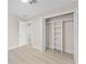 Bright bedroom features a closet, light wood flooring, and a doorway to an adjacent bathroom at 2418 Whitehall Cir, Winter Park, FL 32792