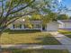 Charming home with a manicured lawn, tidy landscaping, and an inviting driveway at 2418 Whitehall Cir, Winter Park, FL 32792