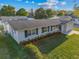 A well-maintained front exterior with a lush lawn, showcasing the property's curb appeal and charm at 2418 Whitehall Cir, Winter Park, FL 32792