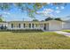 Charming home with dark shutters, a well-kept lawn, and an attached garage, offering comfort and style at 2418 Whitehall Cir, Winter Park, FL 32792